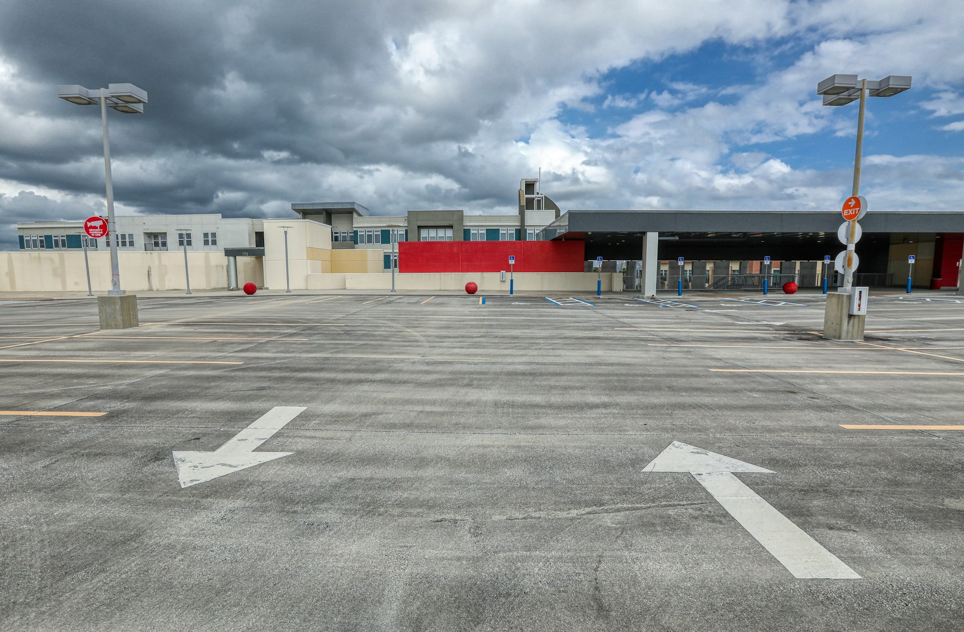 white and red building under white clouds during daytime